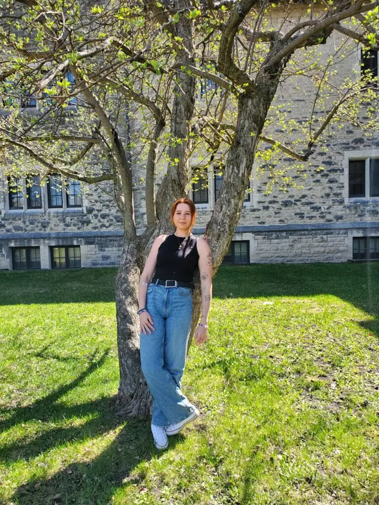 Sophia in front of a tree