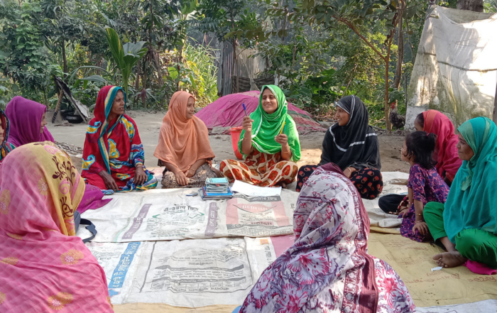 Youth in Bangladesh sit in a circle